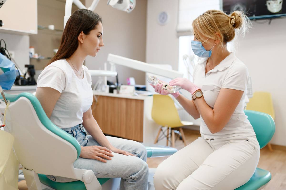Dentist talks to his patient