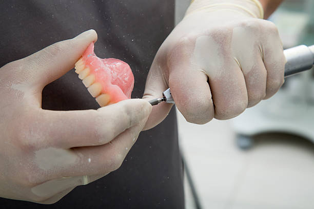 Dentista repara una dentadura postiza