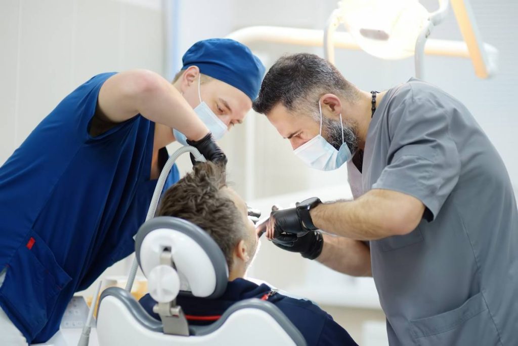 Surgeon and nurse during a dental operation.