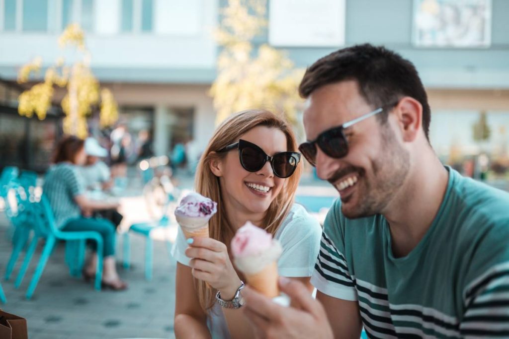 beautiful young couple having ice creams